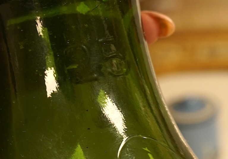 A large green glass carboy 51cm high